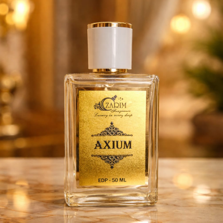 Perfume bottle labeled 'Axium' on a reflective surface with a blurred background